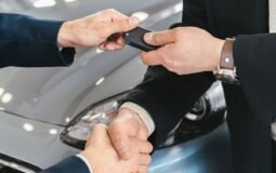 Buyer signing for a new car at a dealership — car loan interest deduction 2026